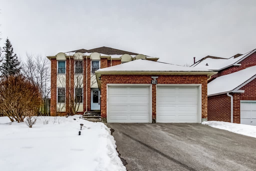 Two-storey brick home with a double garage and snow-covered front yard at 58 Stacey Crescent in Thornlea, Markham.